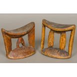 Two African tribal carved wooden headrests Each of typical curved form with end and central carved