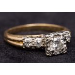 A 14 ct gold and diamond ring With square set central stone above the diamond set shoulders.