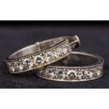 A pair of unmarked white metal, possibly white gold or platinum, diamond set hoop earrings Each 2.