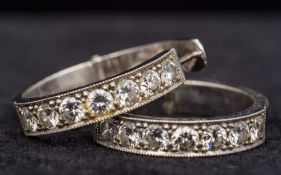 A pair of unmarked white metal, possibly white gold or platinum, diamond set hoop earrings Each 2.