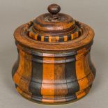 A 19th century Dutch specimen wood tobacco box Of waisted turned lidded form,
