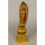 A late 19th/early 20th century Buddhist carved giltwood and lacquered shrine Set with a figure of
