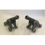 A pair of Victorian cast iron lawn/signal cannons Each barrel supported on a pierced carriage with
