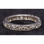 A diamond set platinum eternity ring Of typical form.