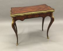 A 19th century gilt bronze mounted kingwood card table The shaped hinged rectangular top enclosing