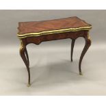 A 19th century gilt bronze mounted kingwood card table The shaped hinged rectangular top enclosing