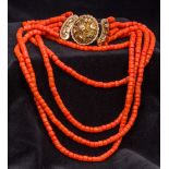 A five strand coral bead necklace Set with an 18 ct gold filigree clasp. Approximately 42 cm long.