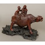 A 19th century Chinese well carved group of boys riding a water buffalo Typically worked and