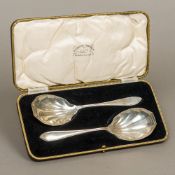 A cased pair of George V silver serving spoons, each hallmarked Sheffield 1933,