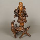 A 19th century Japanese root carving Formed as a scholarly figure holding a gourd,