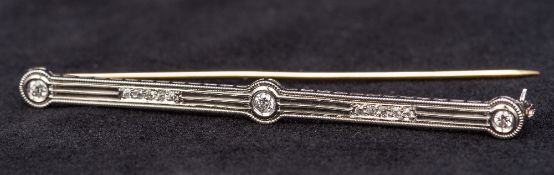 An Art Deco platinum and diamond set bar brooch Of pierced lobed form. 6.5 cm long.