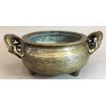 A Chinese cast bronze censer With twin dragon handles, the body with incised decoration,