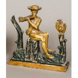 An 18th/19th century Continental carved giltwood and ebonised figure of a gentleman playing the