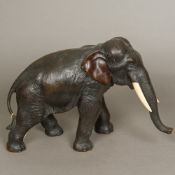 A Japanese Meiji bronze figure of an elephant Typically modelled with ivory tusks,