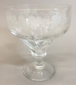 A 19th century oversized wine glass The bowl wheel engraved with fruiting vines. 18 cm high.