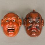 A pair of late 19th century Japanese lacquered masks of Noh Each of male form, set with glass eyes.