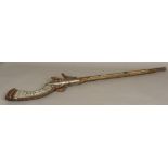 An antique Turkish flintlock musket With typical mother-of-pearl inlaid decorations. 109 cm long.