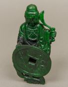 A Chinese carved green hardstone model of Buddha Formed holding a branch and a coin. 13 cm high.