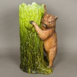 A late Victorian Bretby pottery stick stand Modelled as a brown bear with inset glass eyes leaning