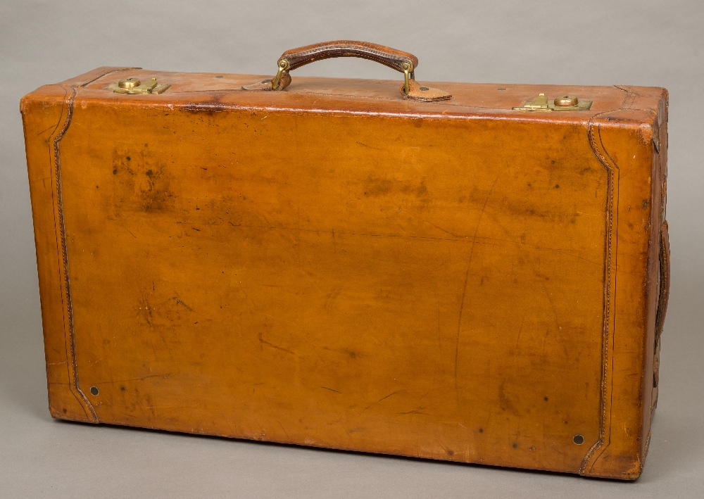 A good quality early 20th century leather covered suitcase Of typical rectangular form with brass