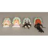 A set of four late 19th century Japanese masks of Noh Each set with a headdress,
