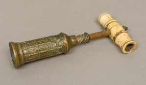 A 19th century Thomason brass corkscrew The turned ivory handle above the cast Gothic barrel,