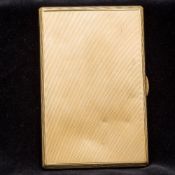 A 9 ct gold cigarette case Of slender hinged form, the exterior with engine turned decoration,