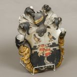 A 19th century painted carved marble heraldic crest Painted with three birds,
