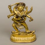 A gilt bronze model of a Tibetan multi-armed tantric deity Modelled holding various objects,