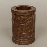 A Chinese carved hardwood brush pot Of cylindrical form,