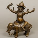 A Chinese patinated bronze figure Modelled as a deity wearing a hat, riding a bejewelled elephant.