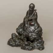 An 18th century Chinese patinated bronze model of Shao Lao Typically modelled seated,