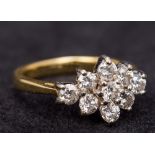 An 18 ct gold diamond cluster ring Set with nine small diamonds. 1.5 cm wide.