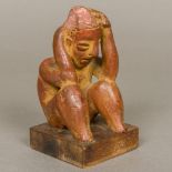 A Colima Pre-Columbian terracotta figure Modelled seated with head in hands,