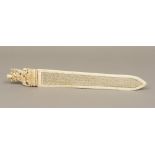 A 19th century Indian carved ivory page turner The handle carved as a multi-armed deity above a