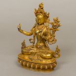 A gilt bronze model of Buddha Modelled seated in the lotus position,