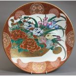 A 19th century Japanese pottery footed bowl Well painted with flowers in a basket within a roundel