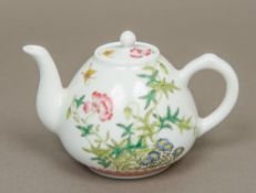 A Chinese Republic style painted porcelain teapot Decorated with butterflies amongst floral sprays,