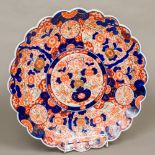 A 19th century Japanese Imari charger Of scalloped edge form, typically decorated to the interior.