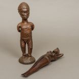 An African carved hardwood figure of a chained slave Together with a carved wooden nutcracker