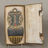 A Chinese ink block Formed as a vase and cover decorated with gilt heightened calligraphy, boxed.