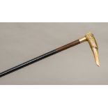 A 19th century carved horn handled walking stick The handle formed as a greyhound with glass inset