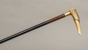 A 19th century carved horn handled walking stick The handle formed as a greyhound with glass inset