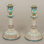 A pair of enamel decorated silver and rock crystal candlesticks Each with removable drip-pan above