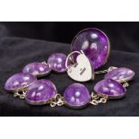 A cabochon amethyst set silver bracelet With heart shaped padlock clasp hallmarked for Birmingham