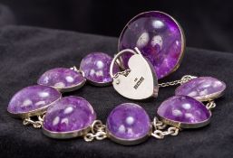 A cabochon amethyst set silver bracelet With heart shaped padlock clasp hallmarked for Birmingham