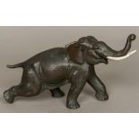 A Japanese Meiji period patinated bronze model of an elephant Naturalistically modelled on all