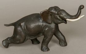 A Japanese Meiji period patinated bronze model of an elephant Naturalistically modelled on all