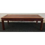 A Chinese carved hardwood low table The panelled rectangular top above the carved frieze,