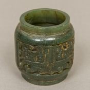 A Chinese carved spinach jade roundel